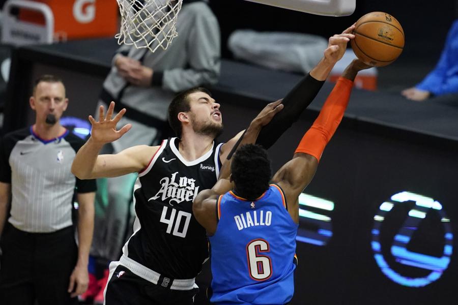 Los Angeles Clippers center Ivica Zubac (40) blocks a shot by Oklahoma City Thunder guard Hamidou Diallo (6) during the first quarter of an NBA basketball game Sunday, Jan. 24, 2021, in Los Angeles. (AP Photo/Ashley Landis)