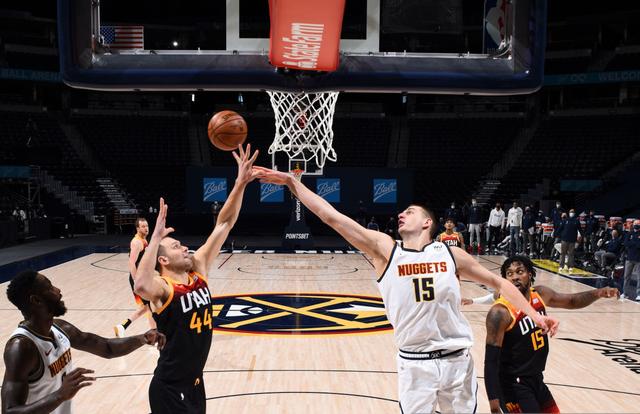 DENVER, CO - JANUARY 31: Bojan Bogdanovic #44 of the Utah Jazz and Nikola Jokic #15 of the Denver Nuggets fight for the rebound during the game on January 31, 2021 at the Ball Arena in Denver, Colorado. NOTE TO USER: User expressly acknowledges and agrees that, by downloading and/or using this Photograph, user is consenting to the terms and conditions of the Getty Images License Agreement. Mandatory Copyright Notice: Copyright 2021 NBAE (Photo by Garrett Ellwood/NBAE via Getty Images)