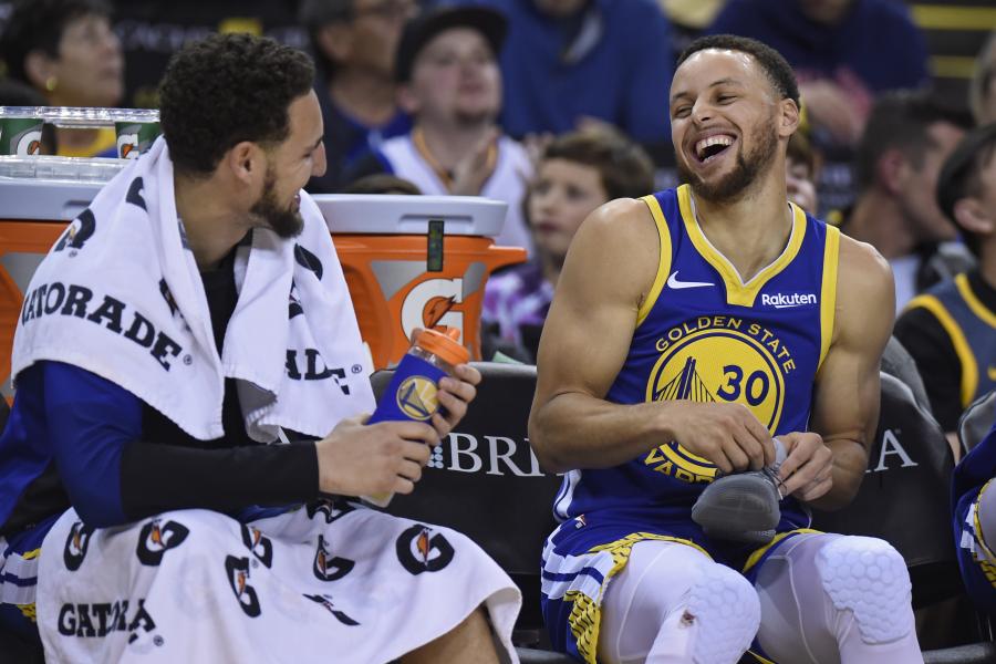 Golden State Warriors' Stephen Curry (30) shares a laugh with teammate Golden State Warriors' Klay Thompson (11) during the fourth quarter of their NBA game at Oracle Arena in Oakland, Calif. on Sunday, March 31, 2019. The Golden State Warriors defeated the Charlotte Hornets 137-90. (Jose Carlos Fajardo/Bay Area News Group)