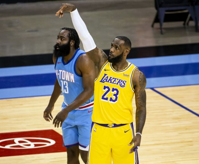 Los Angeles Lakers forward LeBron James (23) watches his shot next to Houston Rockets guard James Harden (13) during an NBA basketball game Tuesday, Jan. 12, 2021, in Houston. (Mark Mulligan/Houston Chronicle via AP)
