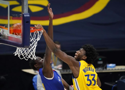 Golden State Warriors center James Wiseman, right, dunks the ball over Denver Nuggets center Bol Bol in the second half of an NBA basketball game Thursday, Jan. 14, 2021, in Denver. (AP Photo/David Zalubowski)