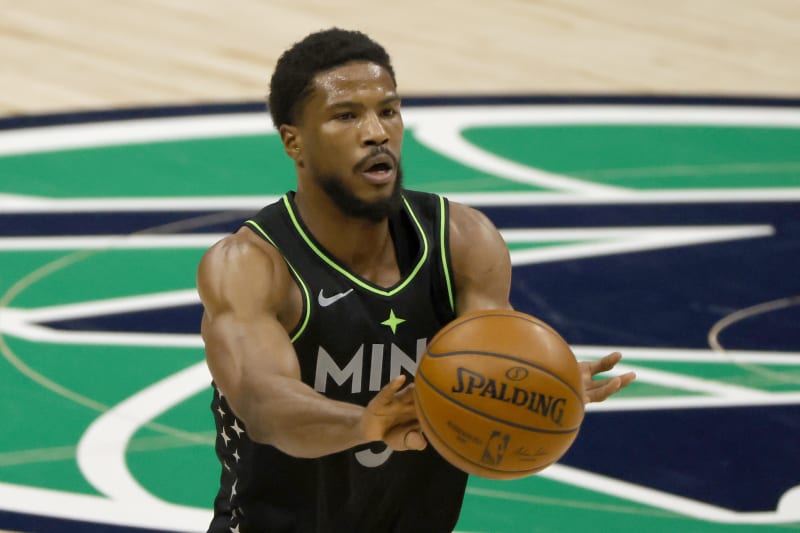 Minnesota Timberwolves guard Malik Beasley (5) passes the ball against the Dallas Mavericks during the second half of an NBA basketball game, Monday, Feb. 8, 2021, in Dallas. (AP Photo/Ron Jenkins)