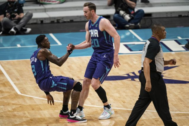 Charlotte Hornets forward Gordon Hayward helps up guard Terry Rozier, left, after Rozier was fouled during the first half of the team's NBA basketball game against the Detroit Pistons in Charlotte, N.C., Thursday, March 11, 2021. (AP Photo/Jacob Kupferman)