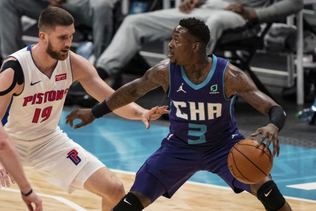 Charlotte Hornets guard Terry Rozier (3) is guarded by Detroit Pistons guard Svi Mykhailiuk (19) during the first half of an NBA basketball game in Charlotte, N.C., Thursday, March 11, 2021. (AP Photo/Jacob Kupferman)