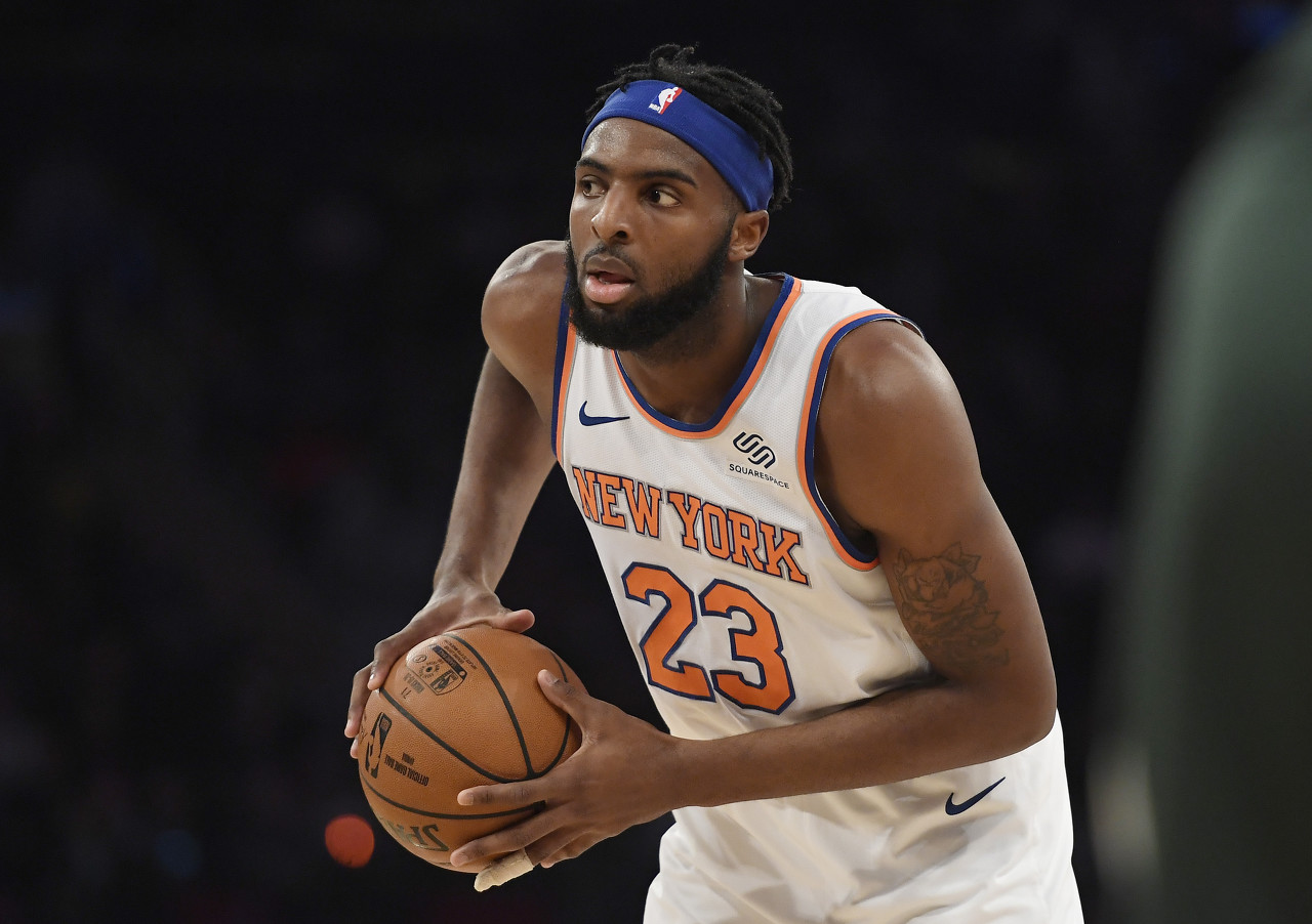 New York Knicks center Mitchell Robinson (23) looks to pass the ball during the first half of an NBA basketball game against the Milwaukee Bucks in New York, Saturday, Dec. 21, 2019. (AP Photo/Sarah Stier)