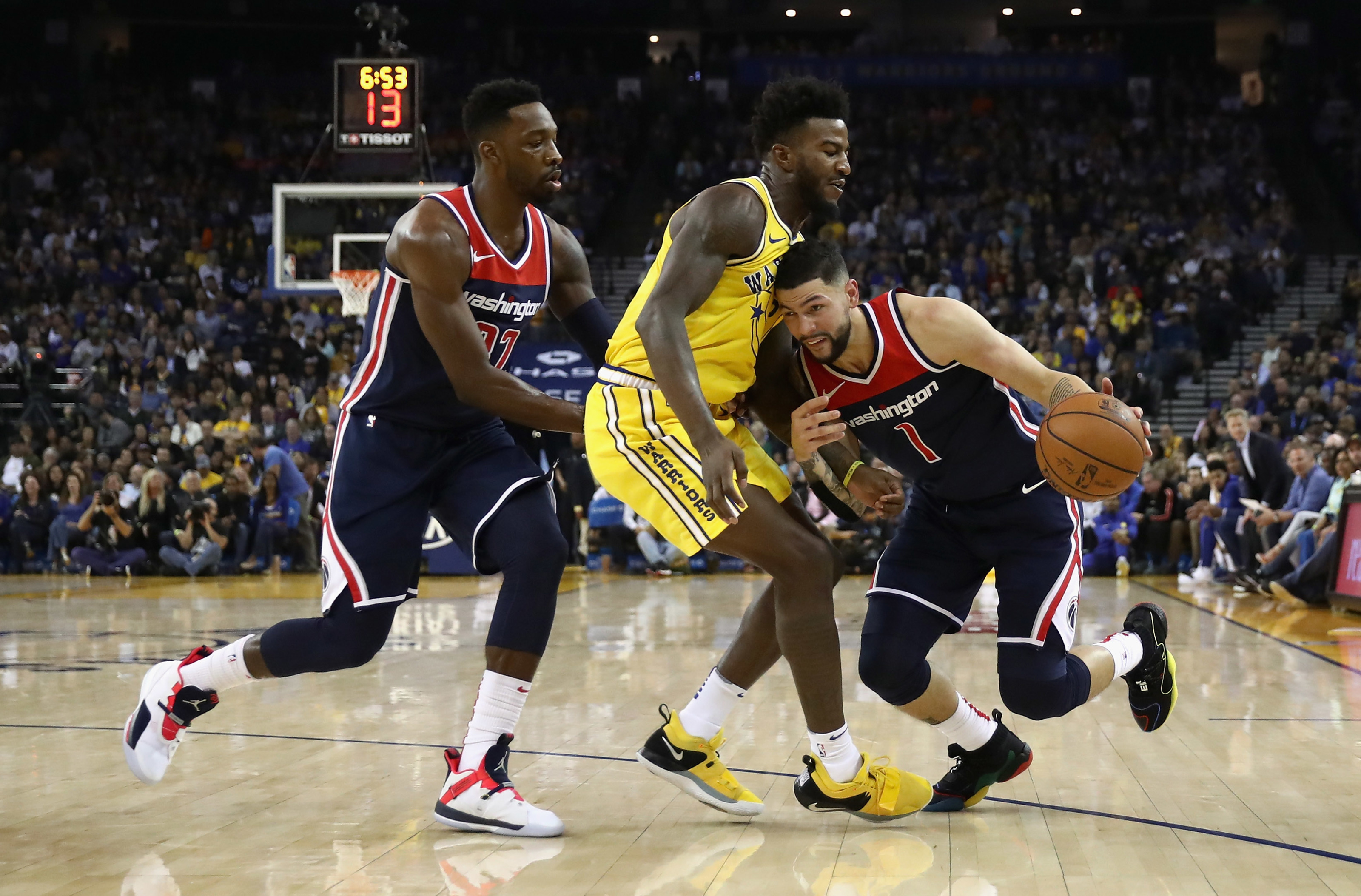 OAKLAND, CA - OCTOBER 24: Austin Rivers #1 of the Washington Wizards is guarded by Jordan Bell #2 of the Golden State Warriors while Jeff Green #32 of the Washington Wizards tries to set a pick at ORACLE Arena on October 24, 2018 in Oakland, California. NOTE TO USER: User expressly acknowledges and agrees that, by downloading and or using this photograph, User is consenting to the terms and conditions of the Getty Images License Agreement. (Photo by Ezra Shaw/Getty Images)