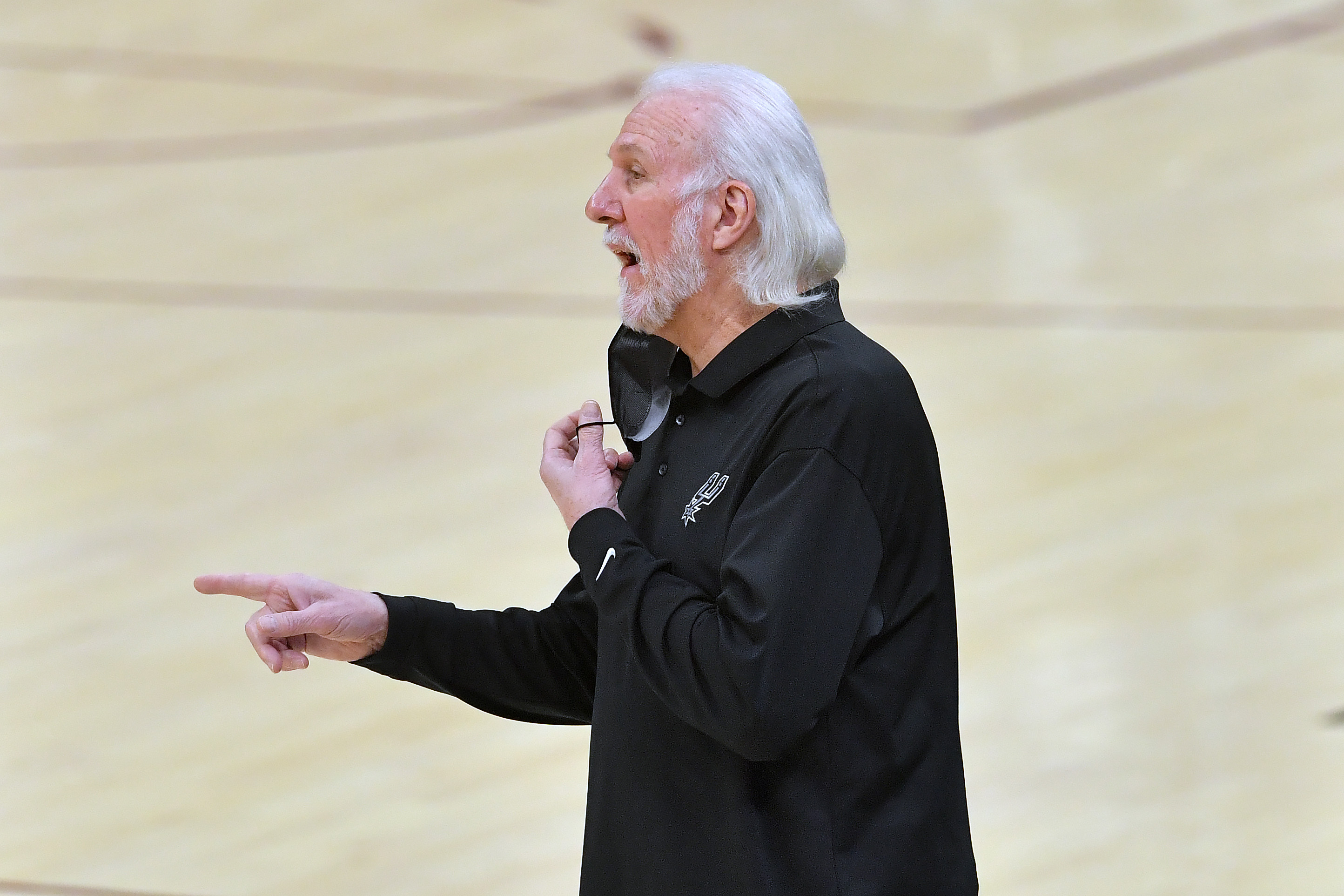 CLEVELAND, OHIO - MARCH 19: Head coach Gregg Popovich of the San Antonio Spurs talks to his players during the second quarter against the Cleveland Cavaliers at Rocket Mortgage Fieldhouse on March 19, 2021 in Cleveland, Ohio. NOTE TO USER: User expressly acknowledges and agrees that, by downloading and/or using this photograph, user is consenting to the terms and conditions of the Getty Images License Agreement. (Photo by Jason Miller/Getty Images)