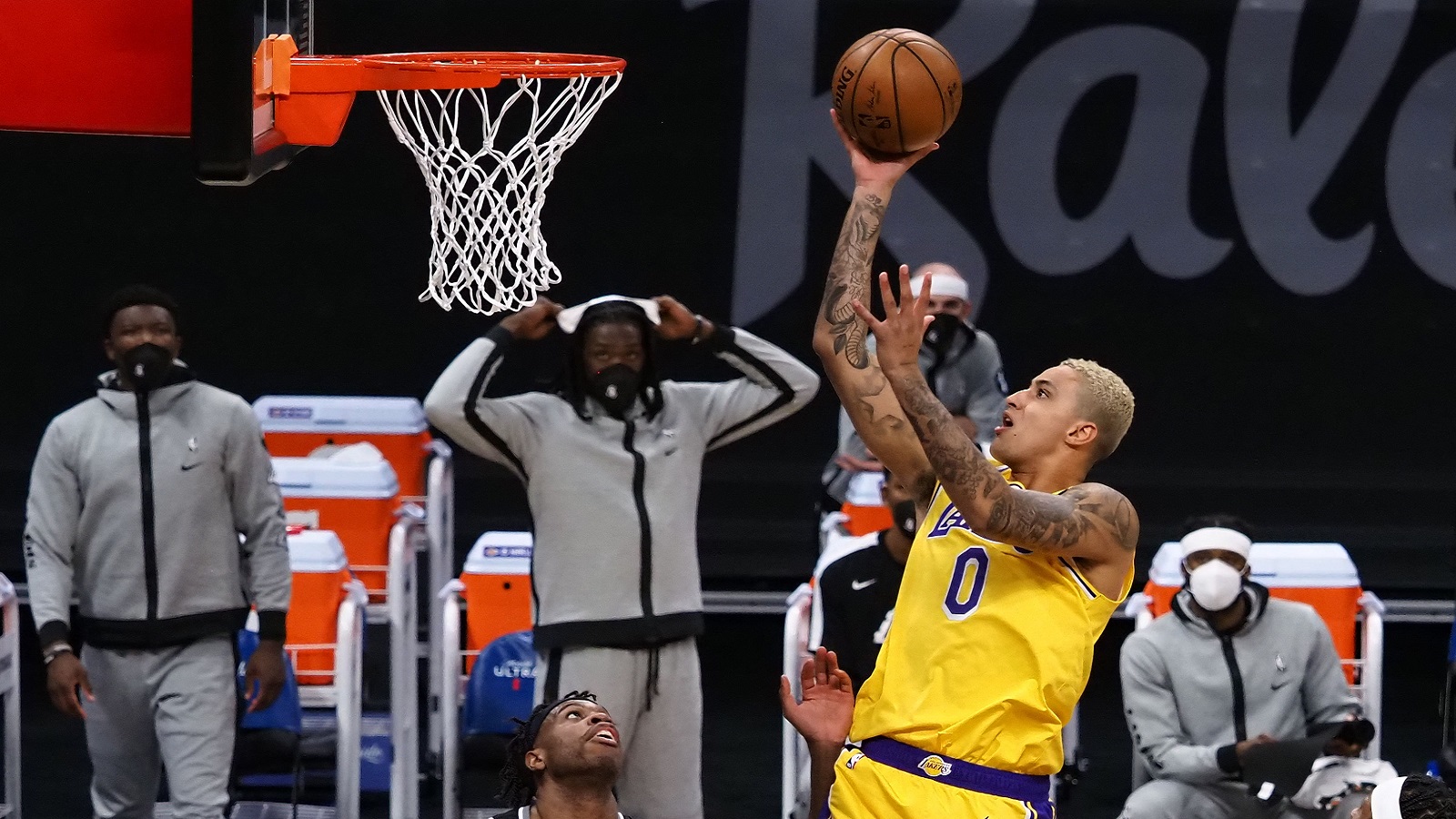 Apr 2, 2021; Sacramento, California, USA; Los Angeles Lakers forward Kyle Kuzma (0) shoots the ball above Sacramento Kings guard Buddy Hield (24) during the first quarter at Golden 1 Center. Mandatory Credit: Kelley L Cox-USA TODAY Sports