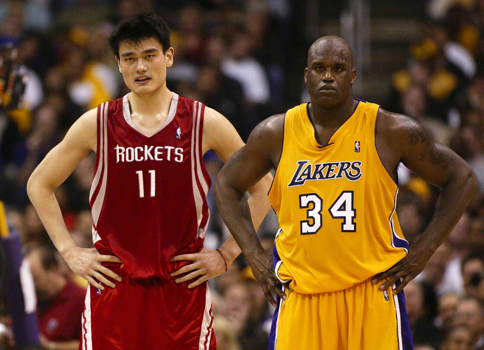 Houston Rockets' Yao Ming, of China, left, stands next to Los Angeles Lakers center Shaquille O'Neal during the second half of a first round NBA Western Conference playoff game on Saturday night, April 17, 2004, in Los Angeles. The Lakers won 72-71. (AP Photo/Mark J. Terrill) ORG XMIT: LAS116