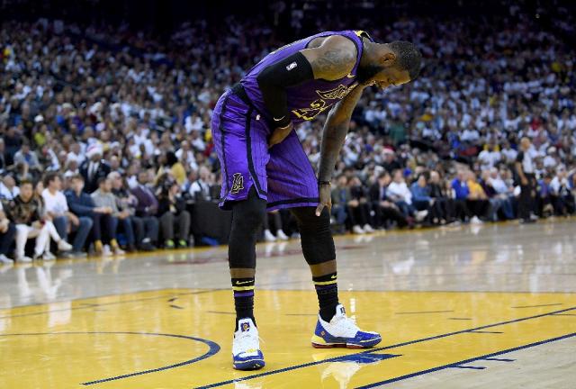 LeBron James injured in Lakers rout of defending champion Warriors